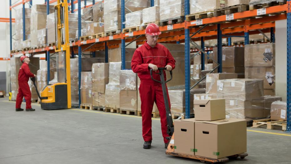 Man in a warehouse carrying out boxes